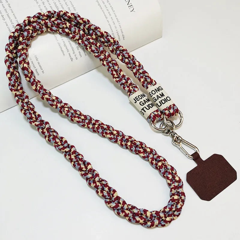 Woven nylon crossbody phone lanyard with macaron pendant in Pink Dot Gray, showing three-strand horse tail detail and matching clip.