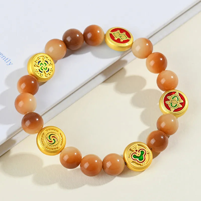 Yellow Bodhi seed bracelet with five directions geometry pattern on wooden surface