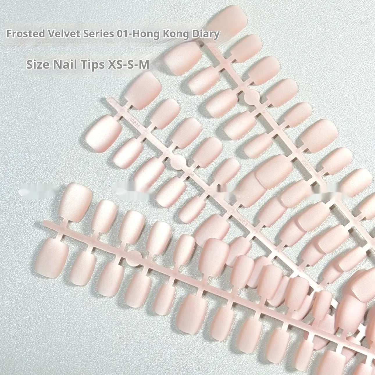 Frosted velvet press-on false nails with electroplated Cat's Eye pattern in short ladder sizes XS, S, and M.