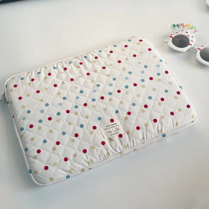 Women's polka dot polyester laptop bag shown in solid colour with size options for 11-inch to 15.6-inch laptops.