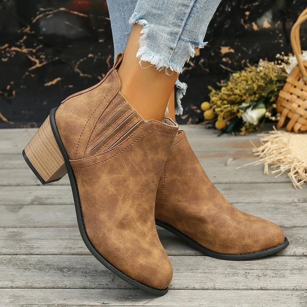 Black women's ankle boot with pointed toe and thick square low heel, slip-on design