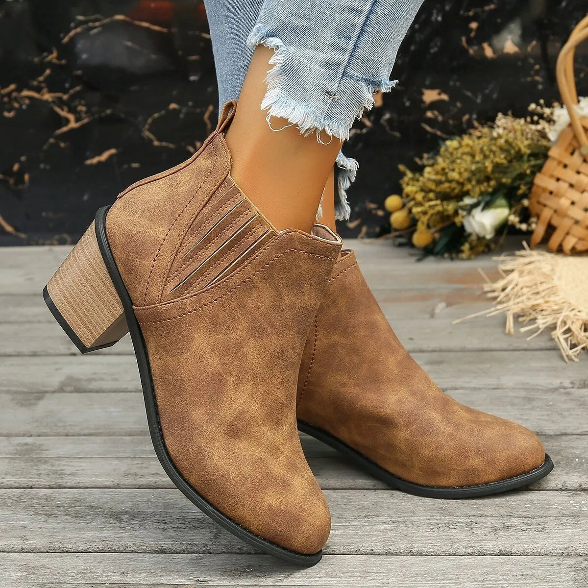 Black women's ankle boot with pointed toe and thick square low heel, slip-on design