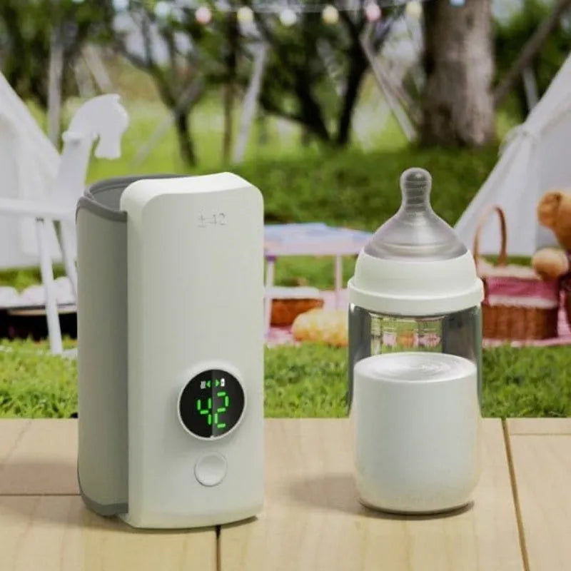 Grey portable USB rechargeable baby bottle warmer with digital display wrapped around a baby bottle.