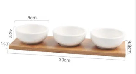 Porcelain ceramic dried fruit dish with compartments on wooden serving board