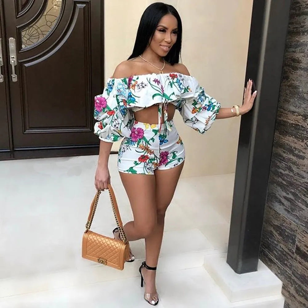 Women's multicolour printed tracksuit set with fleece sleeves on the top and matching shorts.
