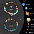 Set of two natural stone beaded bracelets showing zodiac sign designs.