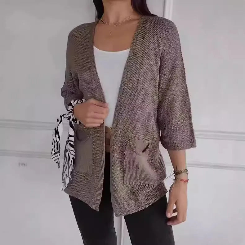 Women's army green waffle knit cardigan coat with nine-quarter length sleeves and pockets.