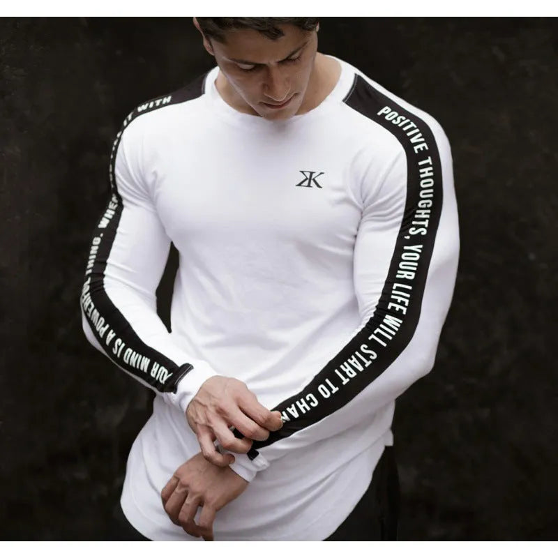 Men's milk silk long sleeve round neck fitness top with letter print in black, shown on a dark background
