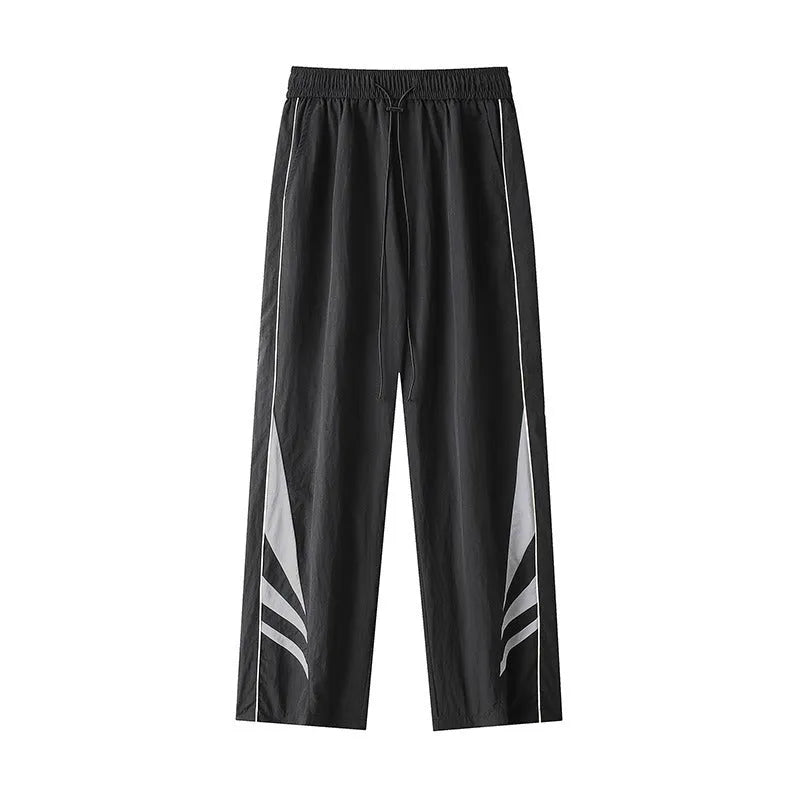 Men's loose fit straight-leg trousers in black, featuring an elasticated waist and button fly.