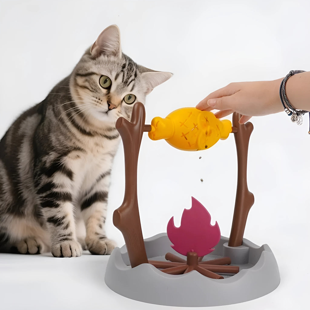 Barbecue style plastic tumbling cat food feeder toy on a white background.