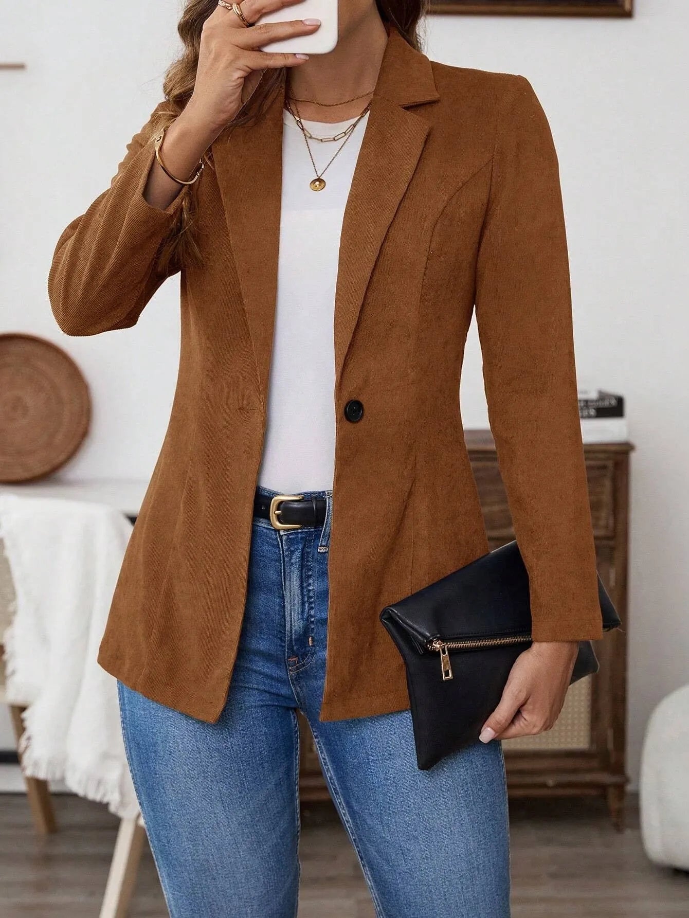 Brown men's single-breasted casual suit coat with long sleeves on a hanger