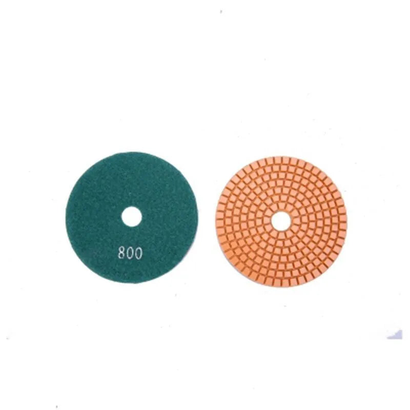 Set of 10 emery stone polishing discs with grits from 50 to 3000 mesh on a grey background.