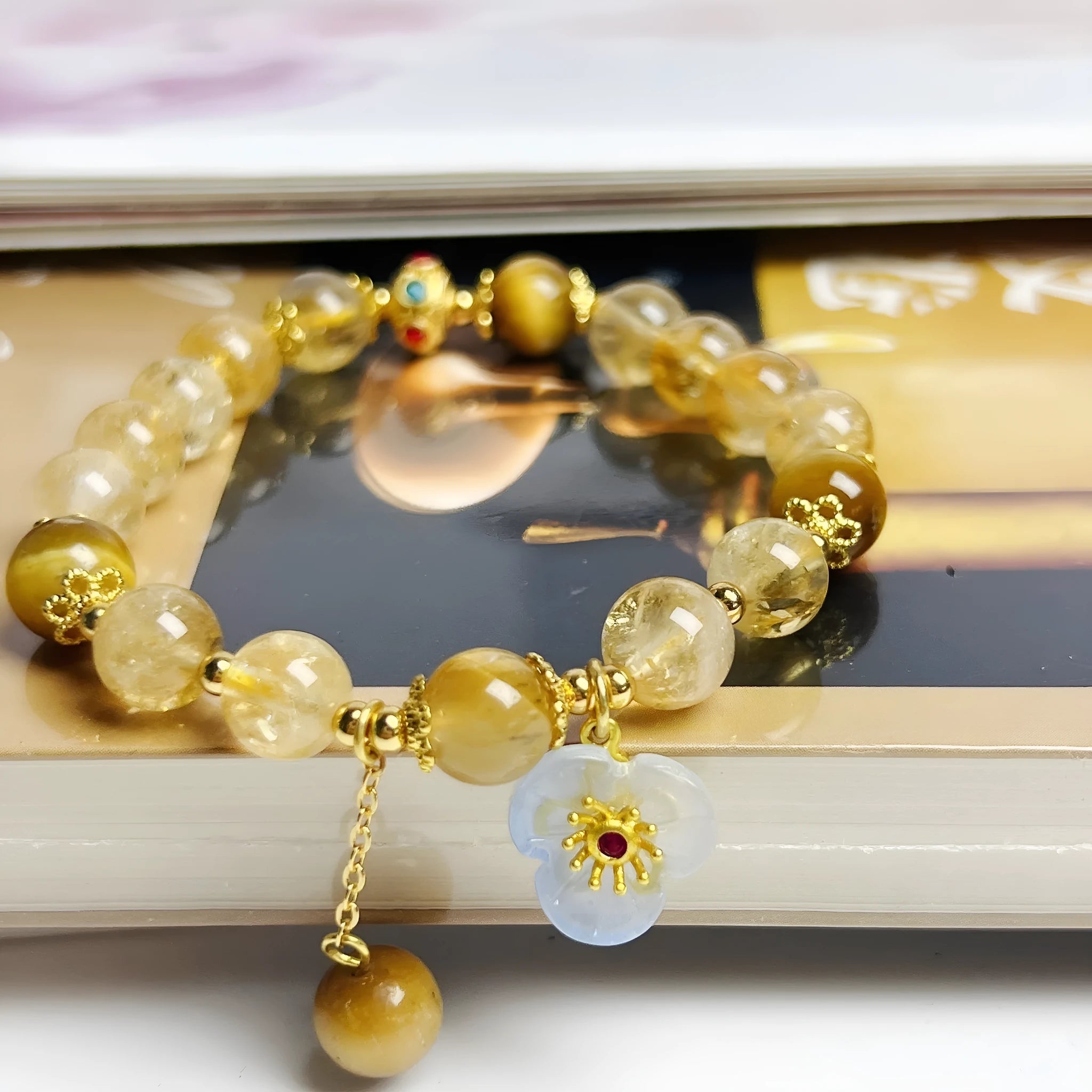 Women's citrine-coloured crystal bracelet with handcrafted flower tassel design