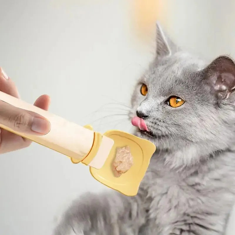 Cat Treat Spoon in green, orange, and white, measuring 27 x 6.5 cm, designed for scooping and serving cat strips
