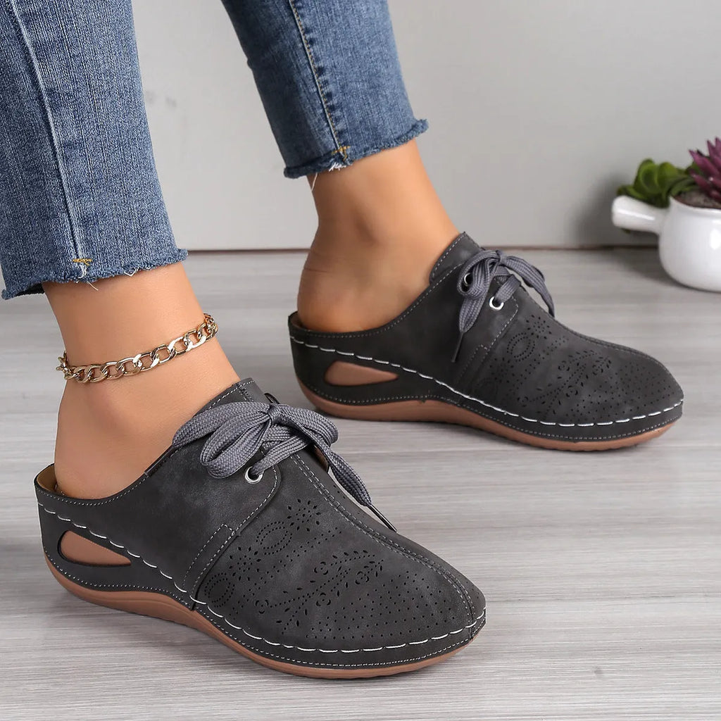 Women's black baotou lace-up slippers with hollow out wedge and suede upper on a rubber sole
