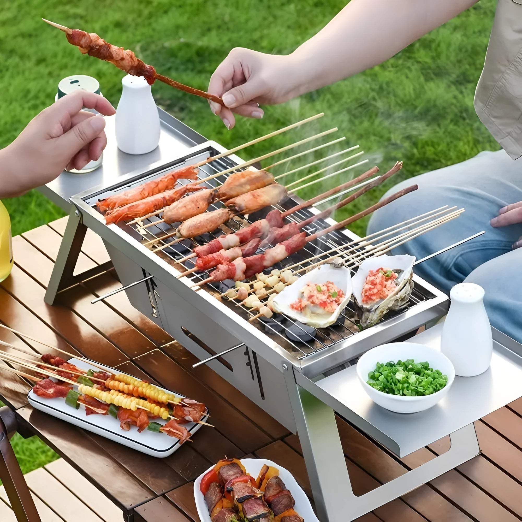 Small foldable steel charcoal grill for portable outdoor barbecues.