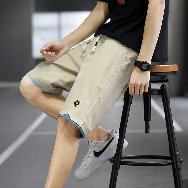 Men's loose-fit casual shorts in polyester fabric, shown in a solid colour with a straight Korean-style cut.
