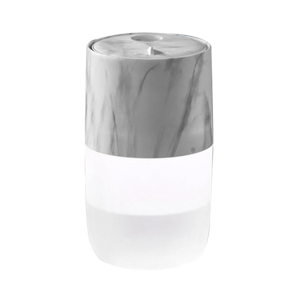 Mini USB jellyfish air humidifier in white with hollow ABS shell on desk