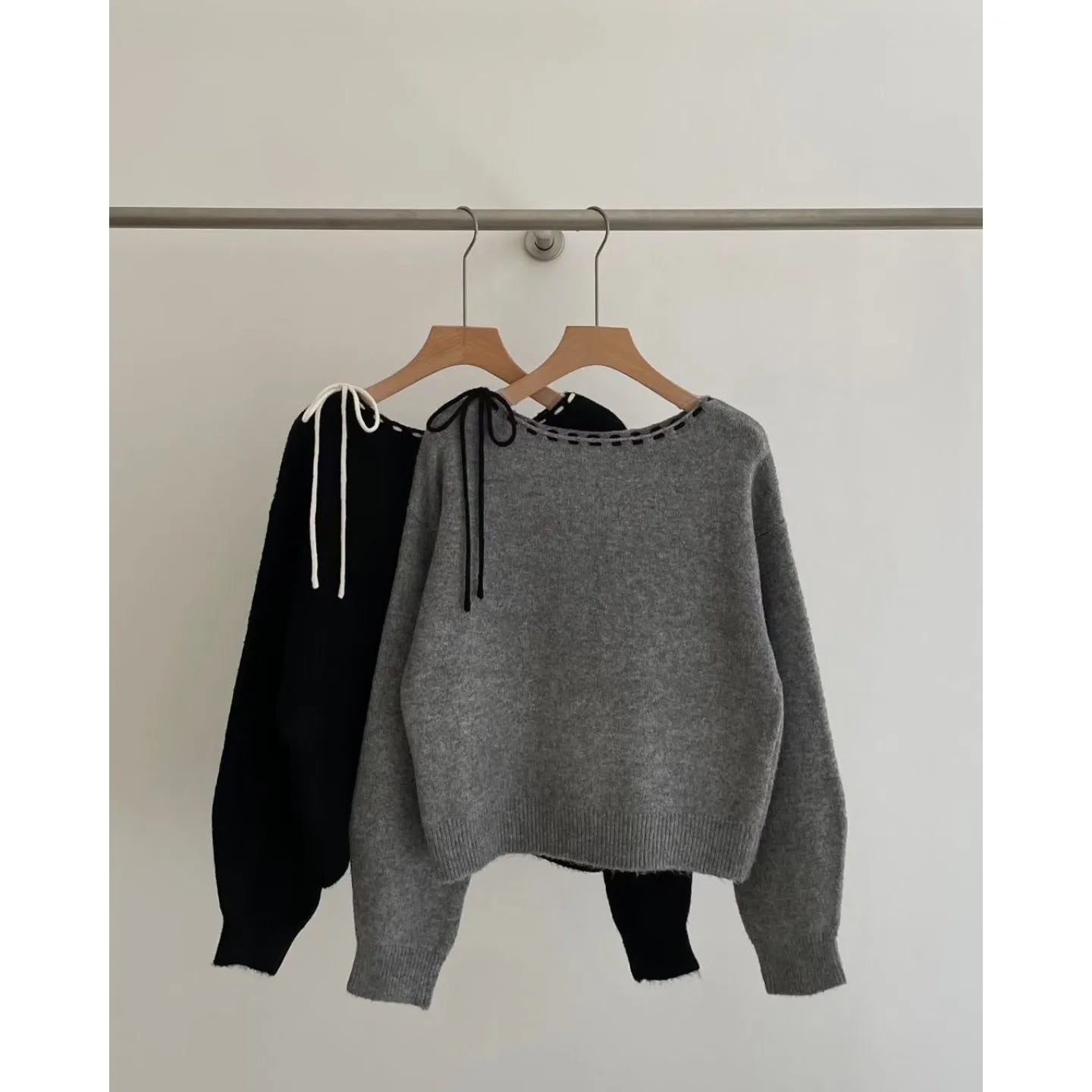 A grey women's loose-fitting pullover knit top made from regenerated cellulose fibre.