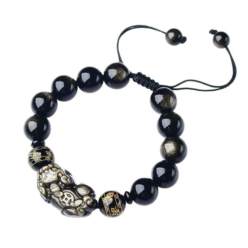 Hand-woven golden obsidian Pi Xiu bracelet with animal zodiac charm on wrist.