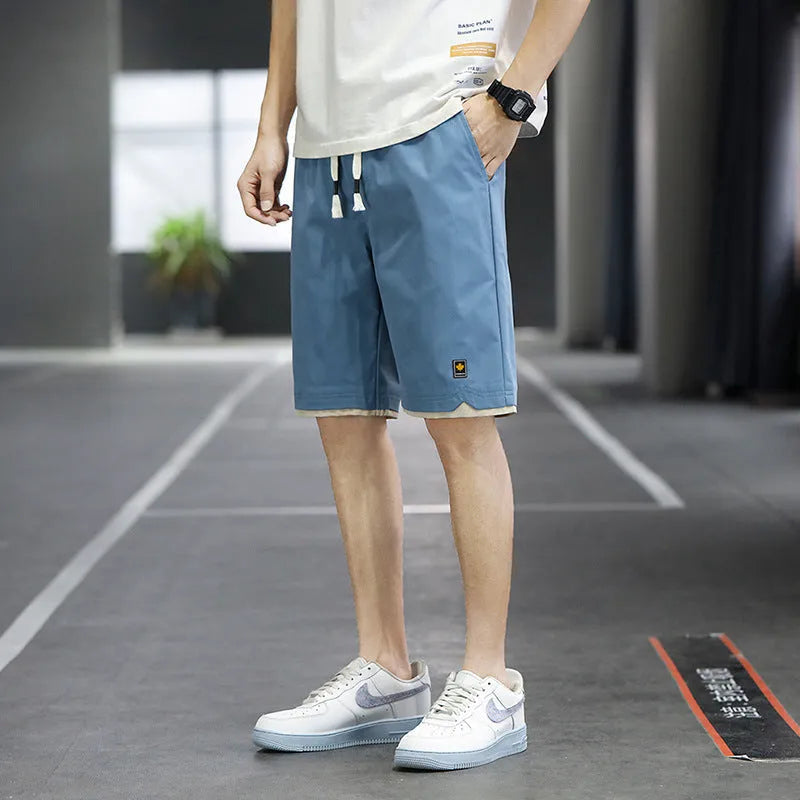Men's loose-fit casual shorts in polyester fabric, shown in a solid colour with a straight Korean-style cut.