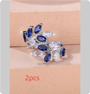 Close-up of an adjustable horse eye zircon leaf fashion ring in a rose gold finish with white stones.