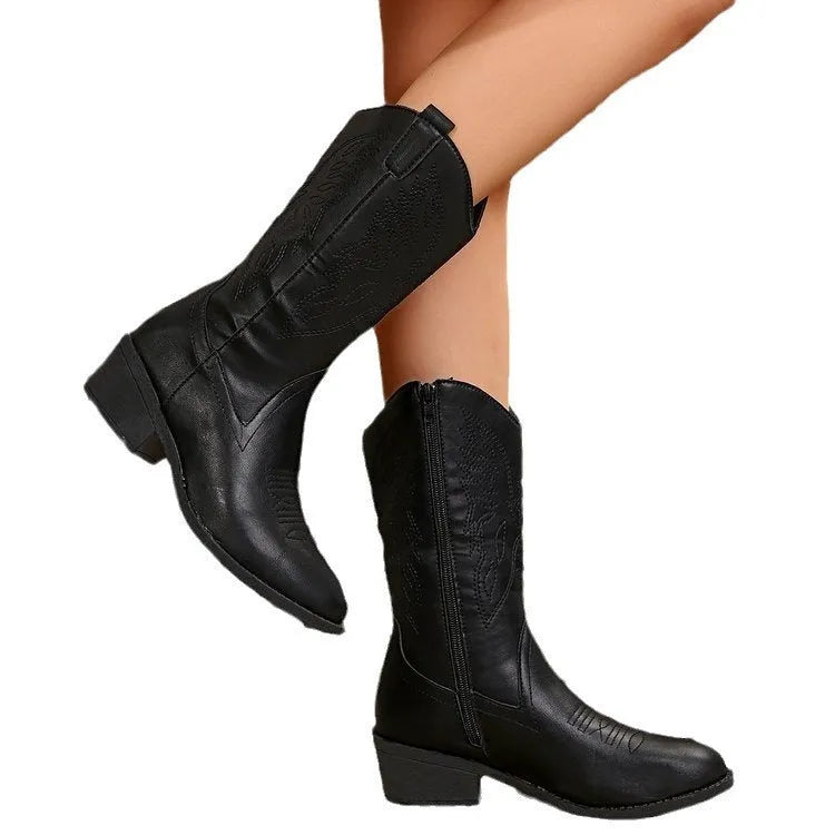 Black women's mid-calf Martin boots with a chunky heel, pointed toe, and hollow-out details.