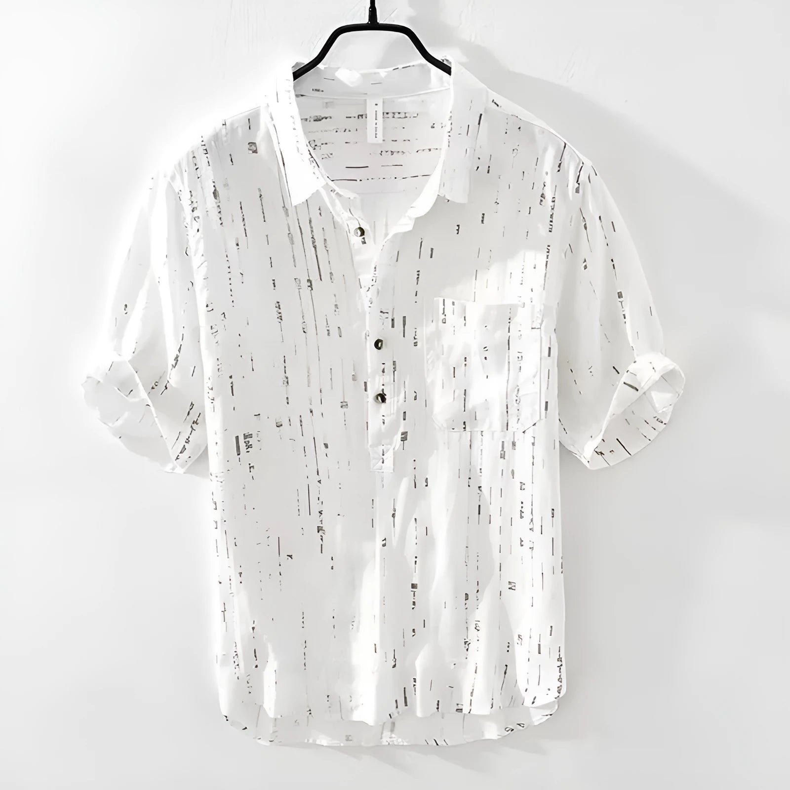 Man wearing a loose-fit black short-sleeve polo shirt, a summer casual style.