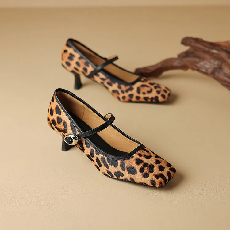 Women's black square toe stiletto heel ankle-strap shoes with horse hair upper on a model.