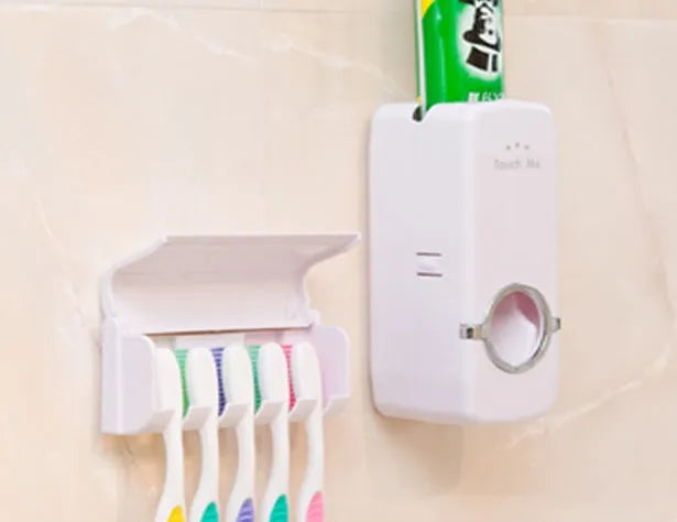 White wall-mounted bathroom set with a toothbrush holder and a pump-action toothpaste dispenser.