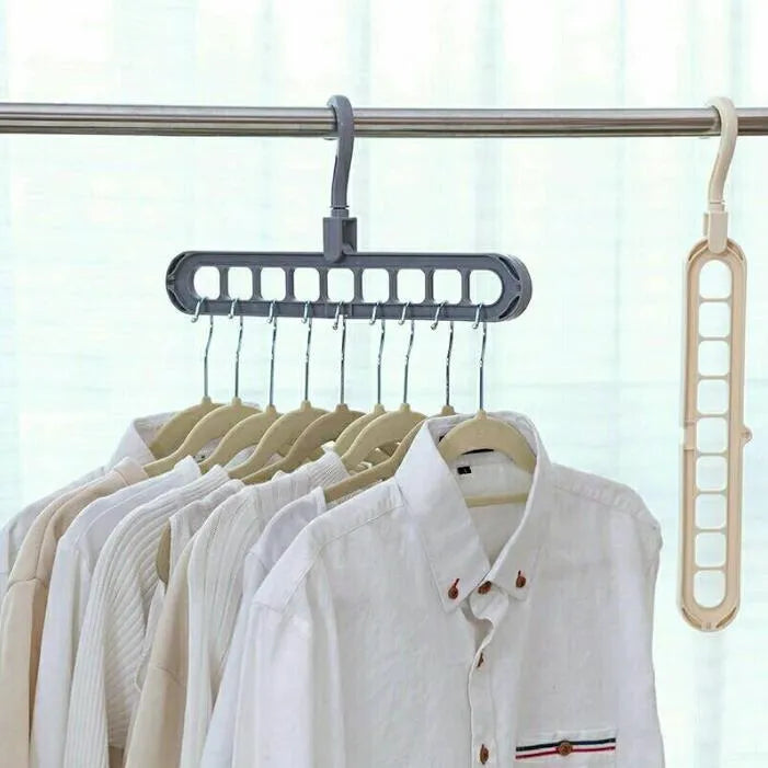 Pink plastic clothes hanger with a rotating hook on a white background.