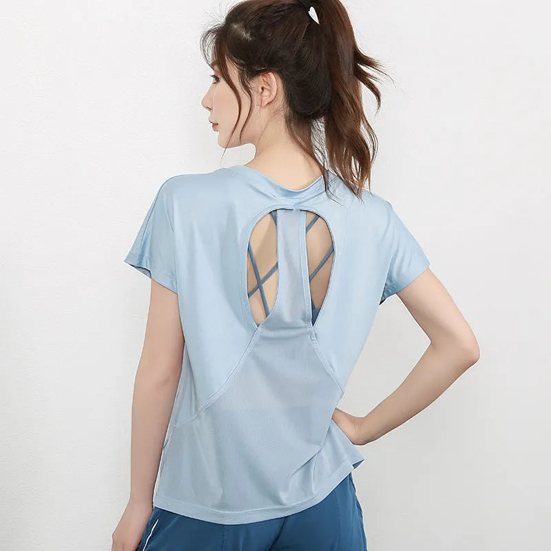 Women's short sleeve polyester sports t-shirt in pink, shown for running and fitness.