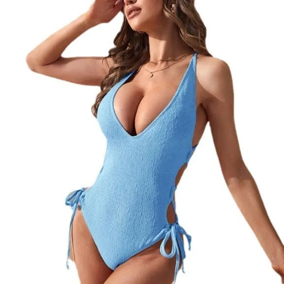 Women's black hollow backless one-piece bikini swimsuit with a central tether strap.