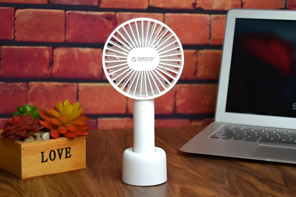 White ORICO FH1 rechargeable USB desktop and handheld fan showing fine line details on its ABS shell.