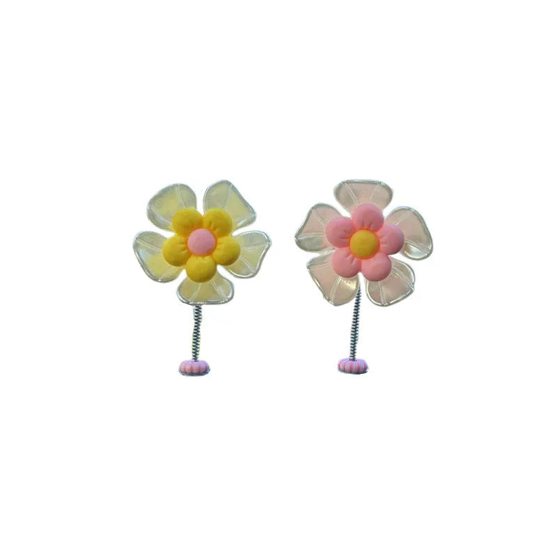 Small colourful plastic swing car decoration for dashboard or mirror.