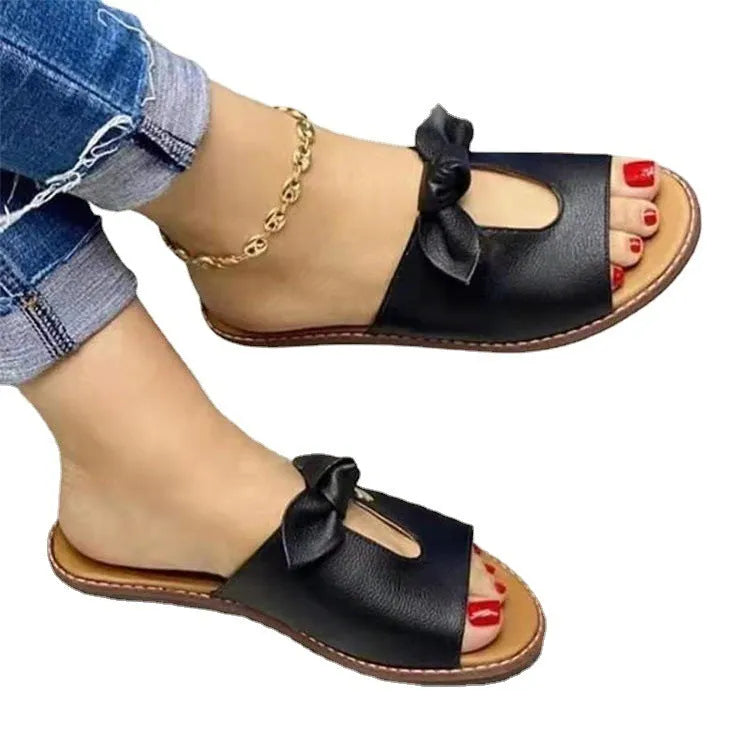 Ladies fish mouth sandals with decorative bow in black, gold, or pink on a rubber sole.