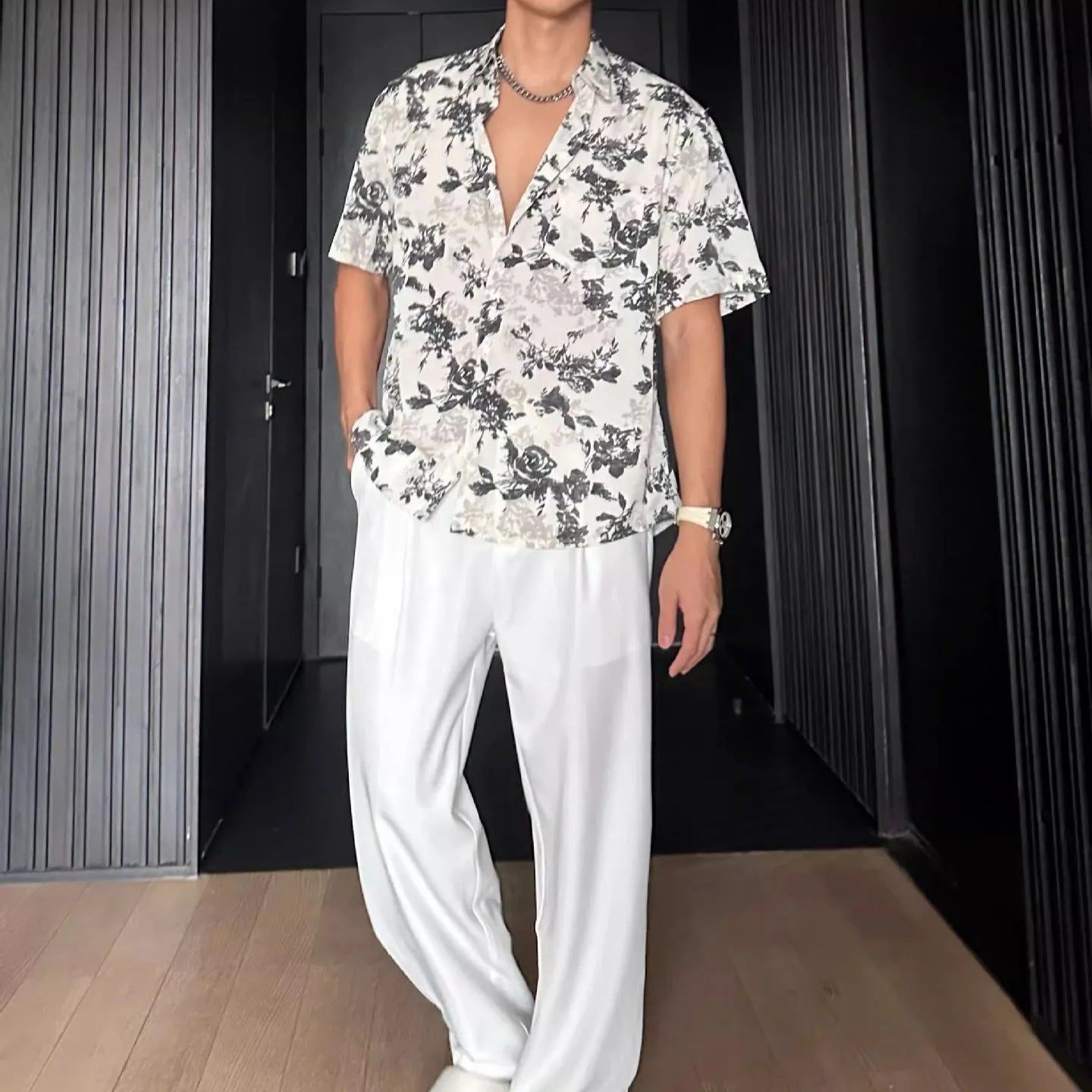 White loose-fit short sleeve casual shirt with a floral print and an open cardigan style front.