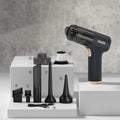 Black wireless car vacuum cleaner with accessories including nozzles and brush heads