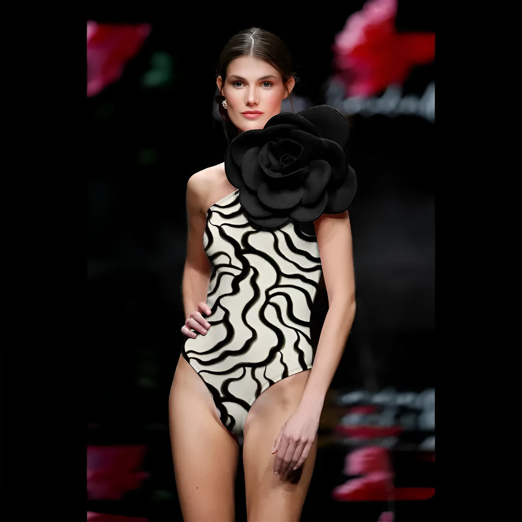 Close-up of a woman's one-piece swimsuit with a three-dimensional floral pattern and a contoured fit.