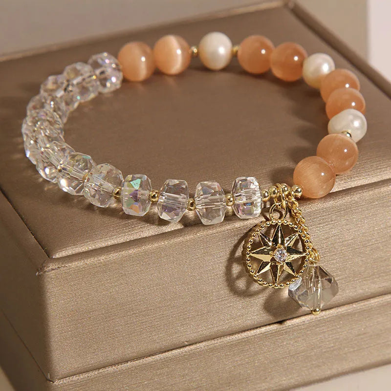 Gold-plated women's bracelet with an eight Awn star design and an orange crystal inlay.
