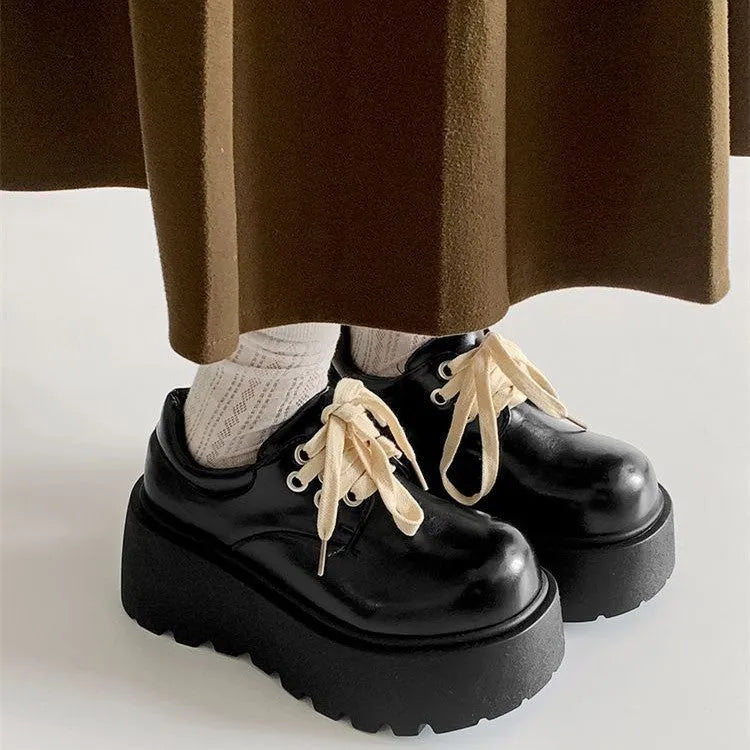 Matte black women's lace-up shoes with a high English muffin heel and thick rubber sole.