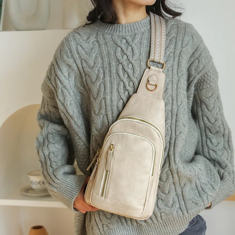 Soft brown PU leather women's crossbody chest bag with open pocket and stitching detail.