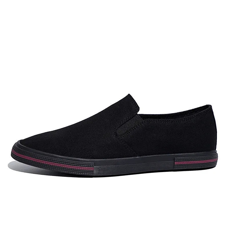 Khaki canvas slip-on sneakers with vulcanised rubber sole and mesh lining on a white background.