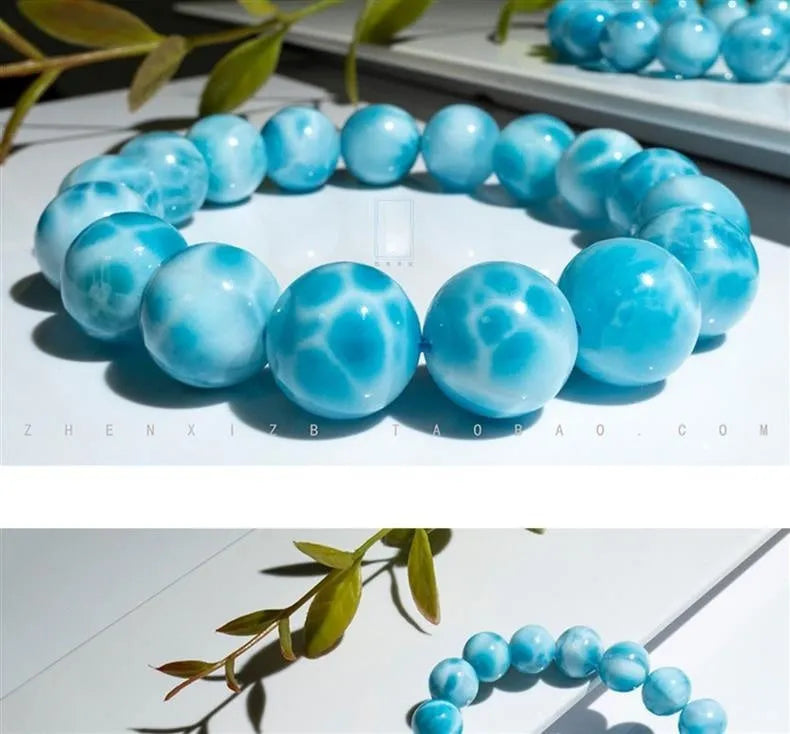 Blue Bodhi bead bracelet with white pearl accents on a plain background.