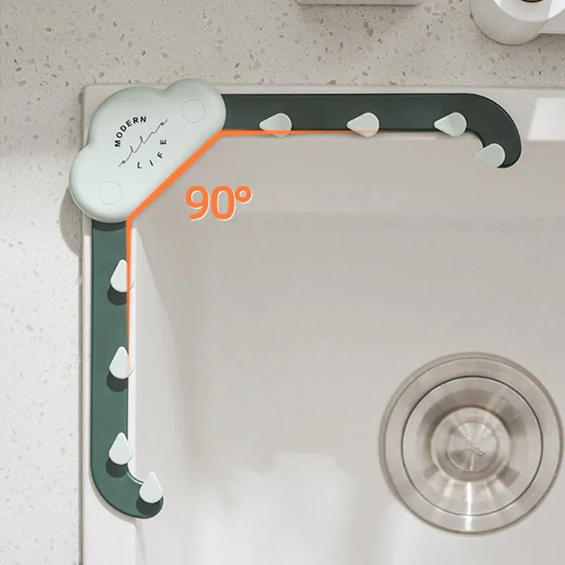 Triangular grey sink drain rack with filter mesh bag installed on a kitchen countertop.
