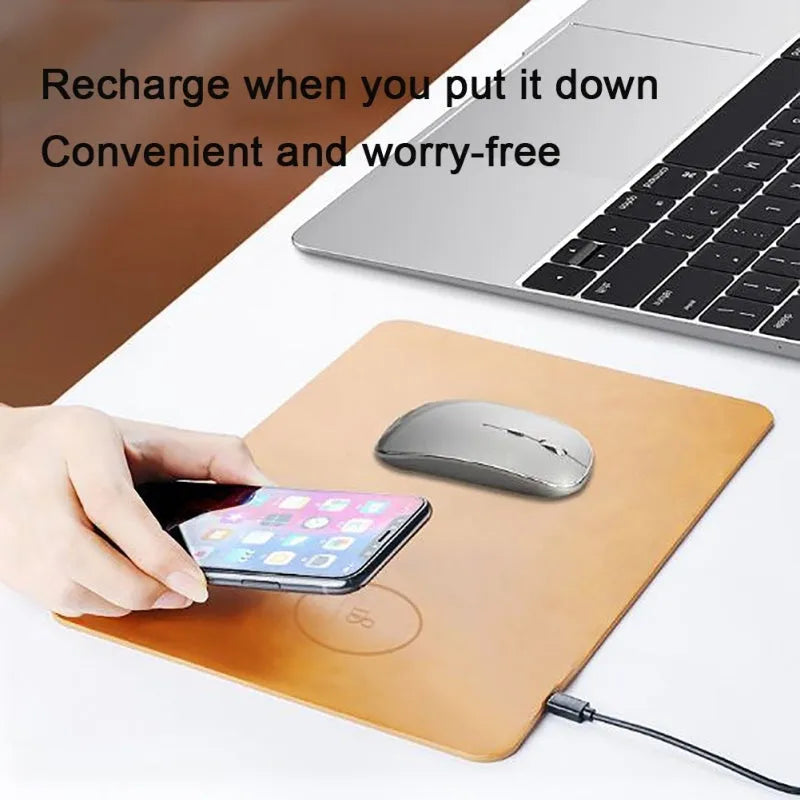 Brown leather desk mouse pad with integrated wireless charging for mobile phones.
