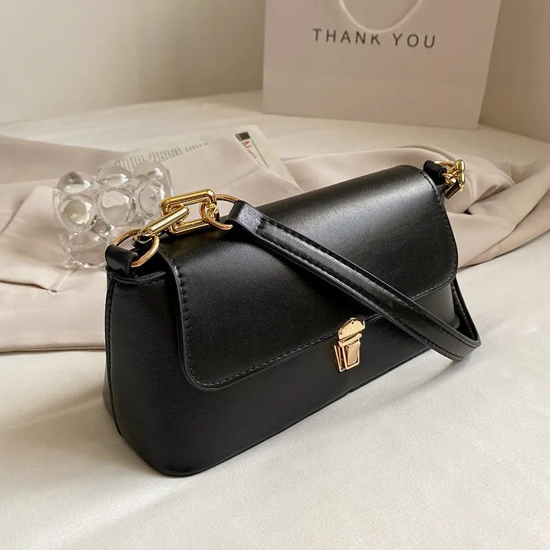 Brown French casual underarm bag with single shoulder chain strap and sandwich pocket design