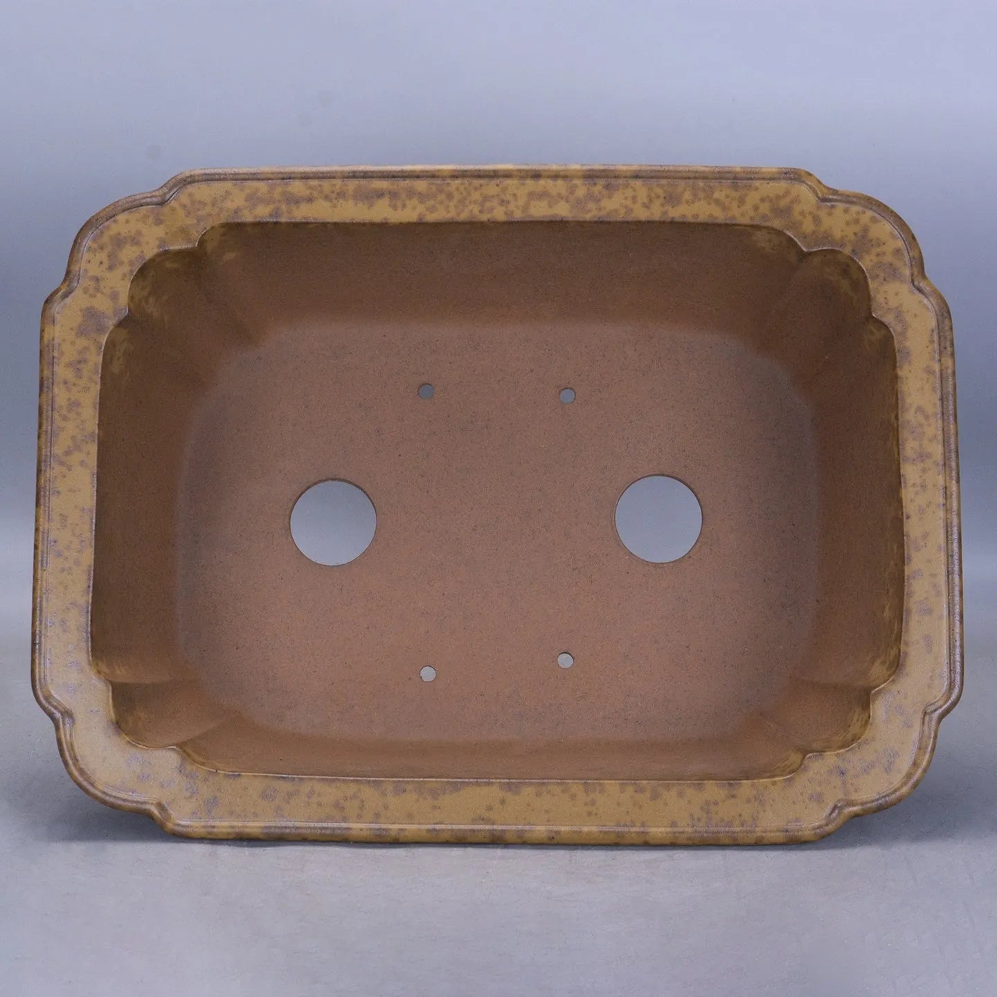 Large rectangular purple sand flowerpot with a double pumping angle design on a floor.
