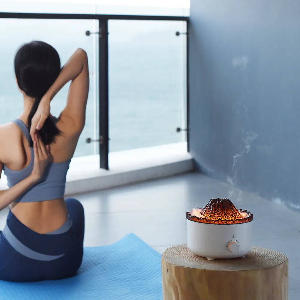 White volcano-shaped humidifier and essential oil diffuser with orange and blue simulated flame light effect.