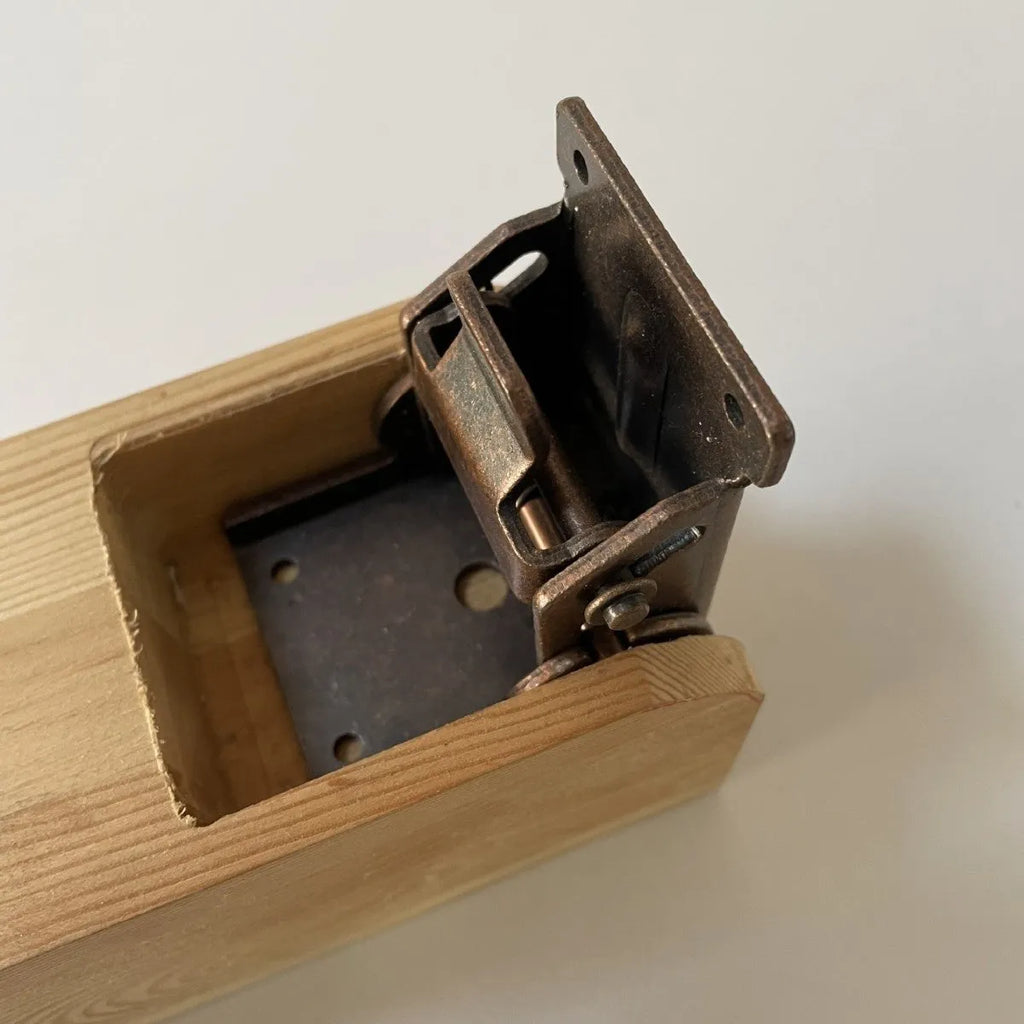 Folding furniture hinge with self-locking mechanism in multiple electroplated finishes including black bronze and matte black.